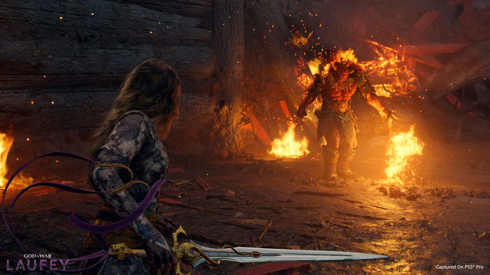 Faye in detailed armor holding an ornate silver sword while facing a massive burning giant wreathed in flames